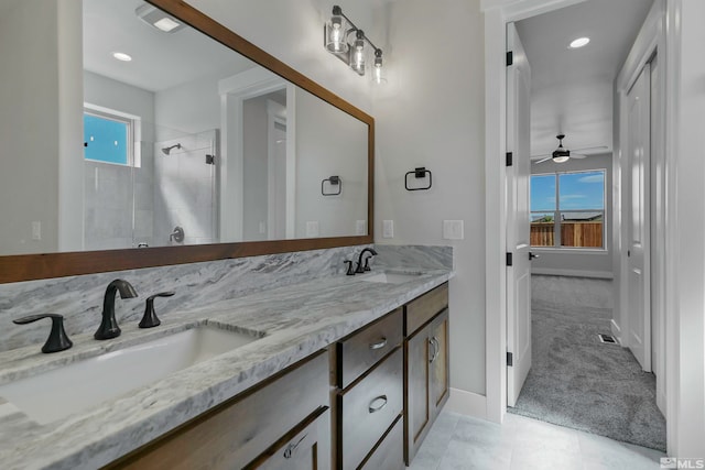 bathroom with plenty of natural light, tile floors, ceiling fan, and dual bowl vanity