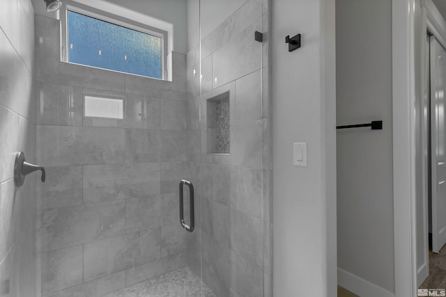 bathroom featuring a shower with door