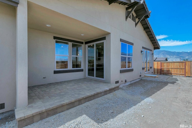 view of side of home featuring a patio and a mountain view