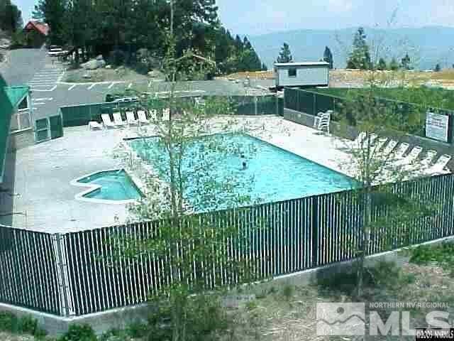 view of swimming pool featuring a patio area and a community hot tub