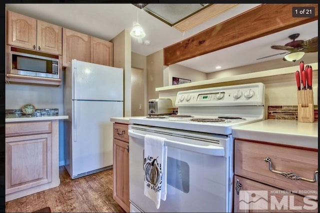 kitchen featuring white appliances, light hardwood / wood-style flooring, ceiling fan, hanging light fixtures, and light brown cabinetry