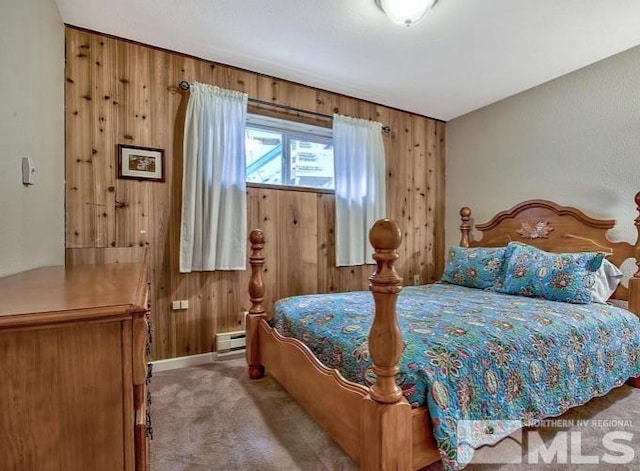 bedroom featuring a baseboard radiator, light carpet, and wooden walls