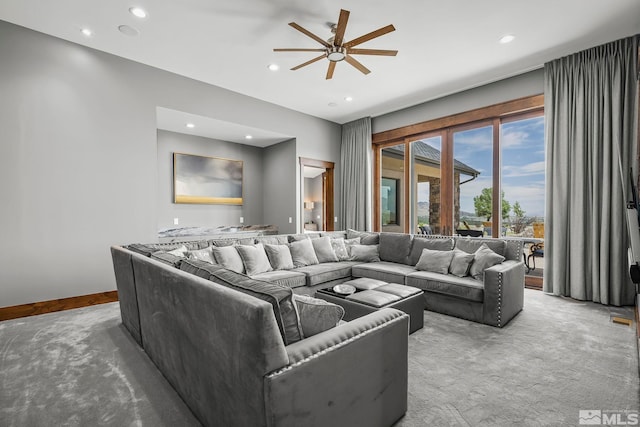 living room with light colored carpet and ceiling fan