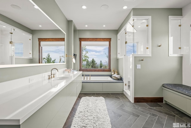 bathroom featuring sink, tiled tub, and tile patterned floors