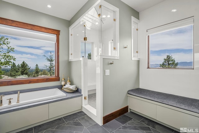 bathroom with a tub and tile patterned flooring