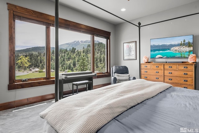 bedroom with a mountain view and carpet flooring