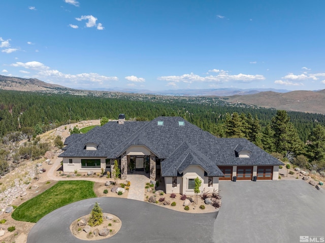 view of front of property featuring a mountain view and a garage