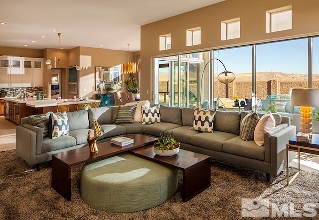 living room with plenty of natural light and a chandelier