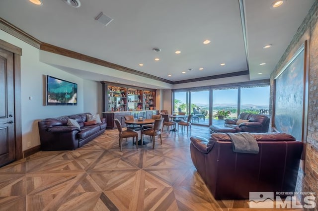 living room with light parquet flooring and a tray ceiling