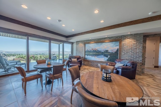 dining area with light parquet floors and brick wall