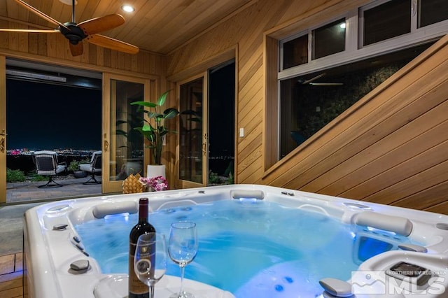 exterior space with a hot tub and ceiling fan