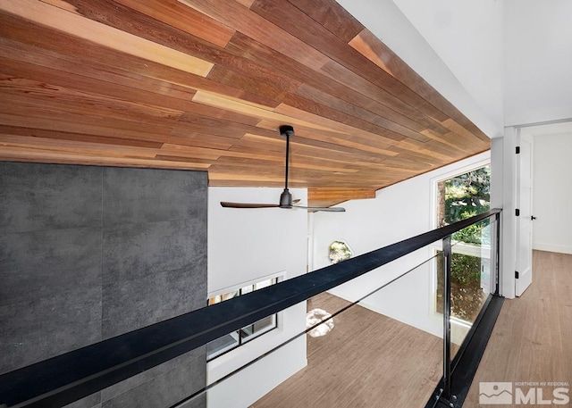 room details with wood ceiling, wood-type flooring, and ceiling fan