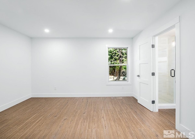 unfurnished room with light hardwood / wood-style flooring