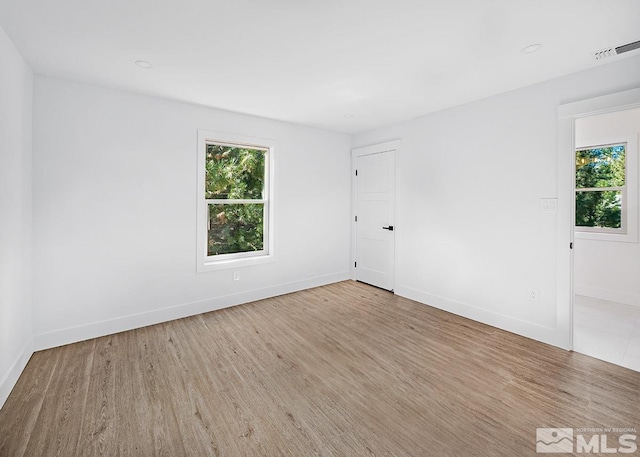 spare room featuring light wood-type flooring