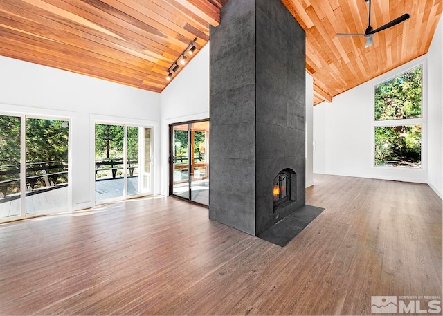 unfurnished living room with a tiled fireplace, ceiling fan, wood ceiling, high vaulted ceiling, and wood-type flooring