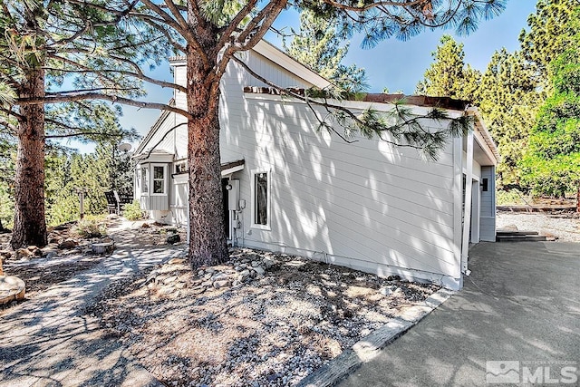 view of side of home with a garage