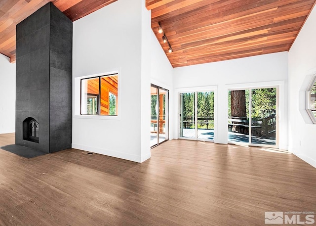 unfurnished living room with high vaulted ceiling, hardwood / wood-style flooring, and wood ceiling