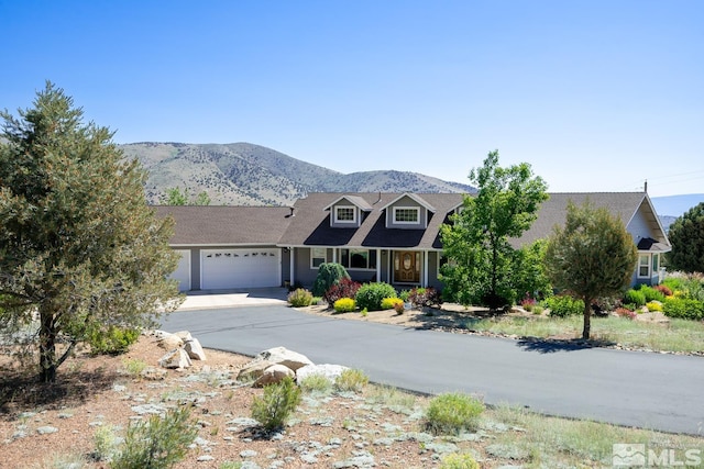 view of front of house with a garage and a mountain view