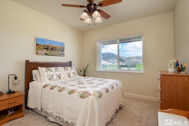 bedroom featuring light carpet and ceiling fan