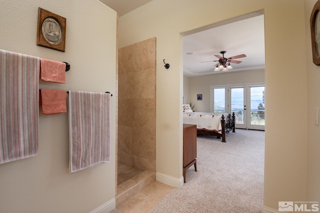 bathroom featuring ceiling fan, crown molding, and french doors