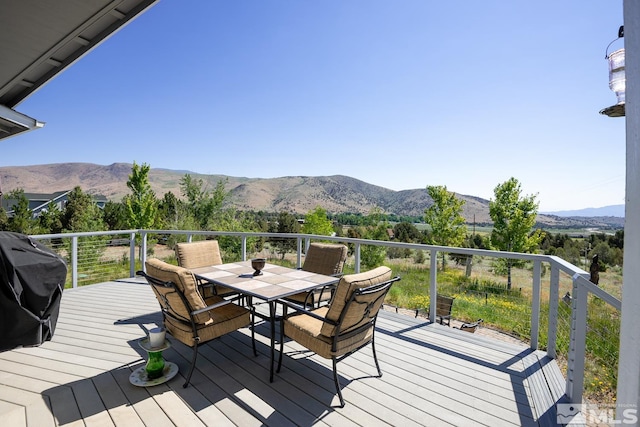 wooden deck featuring a grill and a mountain view