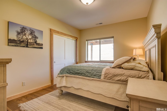 bedroom with light hardwood / wood-style flooring and a closet