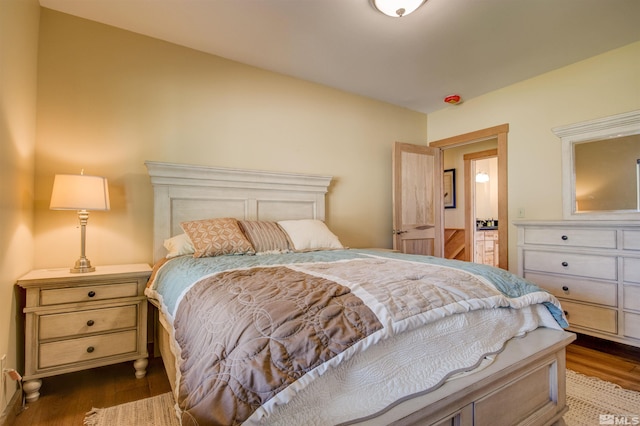 bedroom with dark hardwood / wood-style flooring