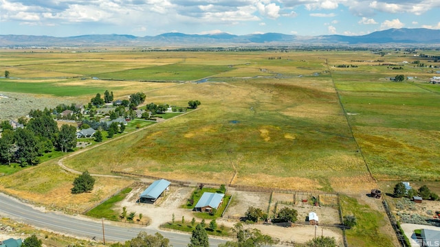 birds eye view of property featuring a mountain view and a rural view