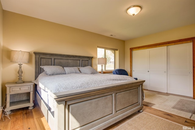 bedroom with a closet and light hardwood / wood-style flooring