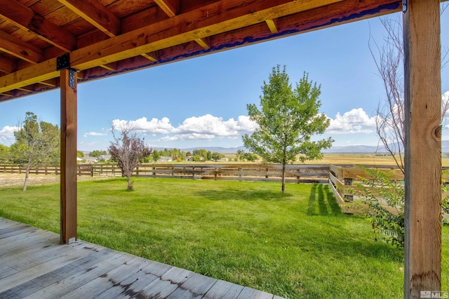 view of yard with a rural view and a wooden deck