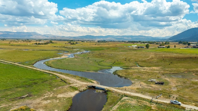 aerial view with a rural view and a water and mountain view