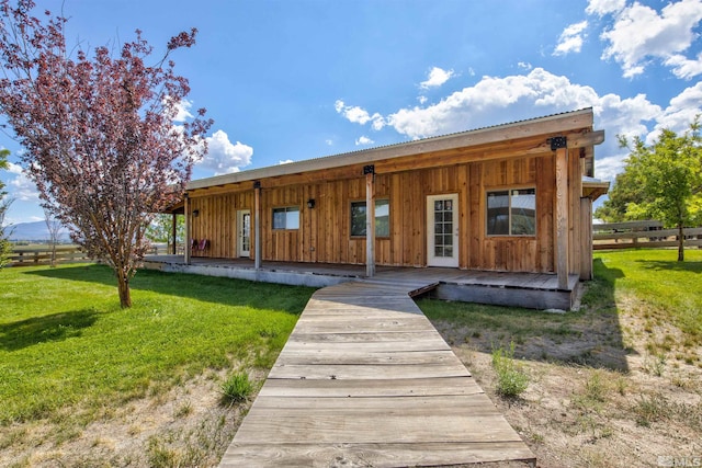 view of front of house featuring a front yard and french doors