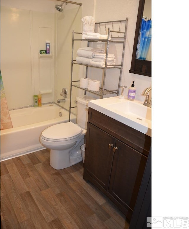 full bathroom featuring vanity, shower / bath combo, wood-type flooring, and toilet