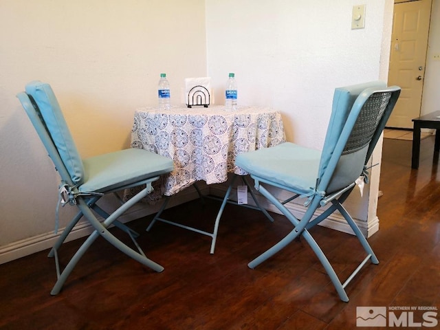 dining space featuring dark wood-type flooring