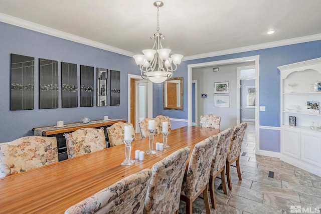 tiled dining space featuring an inviting chandelier and ornamental molding