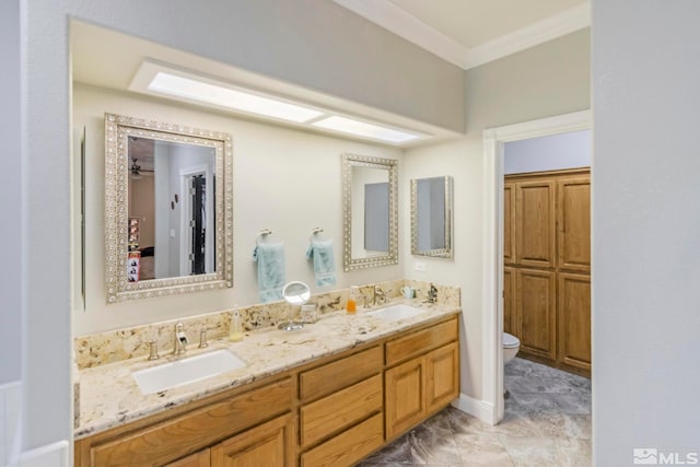 bathroom featuring double sink vanity, toilet, and tile flooring