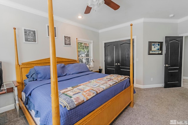 carpeted bedroom featuring ceiling fan, ornamental molding, and a closet