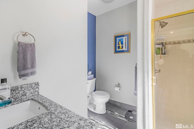 bathroom featuring toilet, a shower with door, and vanity