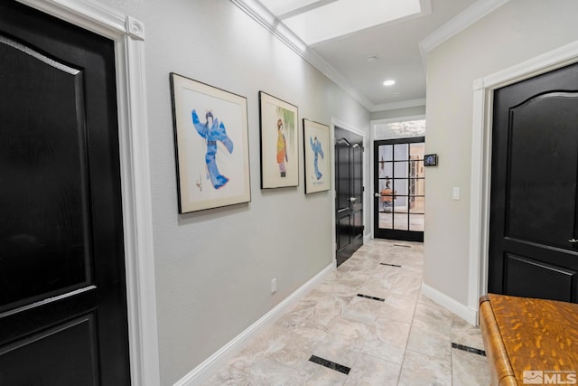 hall with ornamental molding and light tile floors