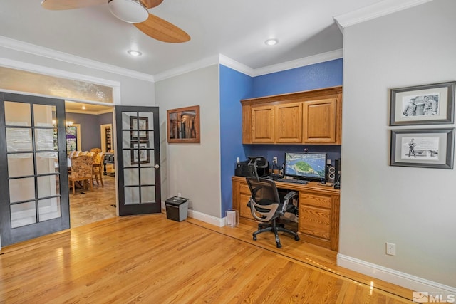 office area with french doors, ceiling fan, crown molding, light hardwood / wood-style floors, and built in desk