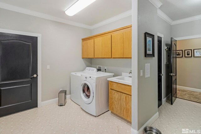 clothes washing area featuring cabinets, light tile floors, washer hookup, washer and dryer, and ornamental molding