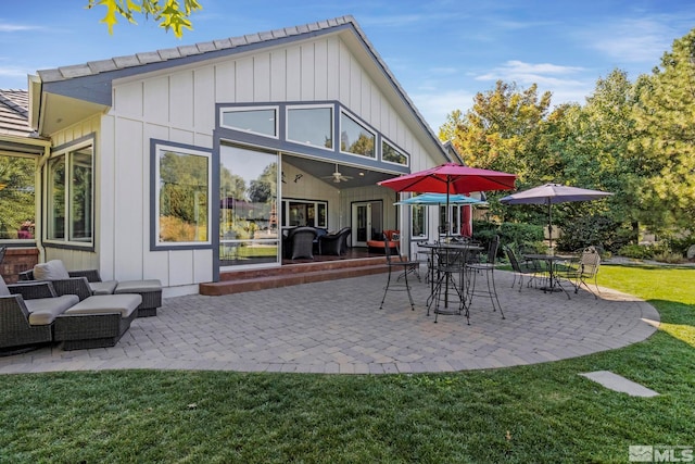 rear view of property with a patio area, a lawn, and outdoor lounge area