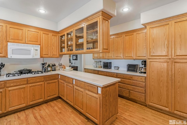 kitchen featuring light hardwood / wood-style floors and stainless steel gas stovetop