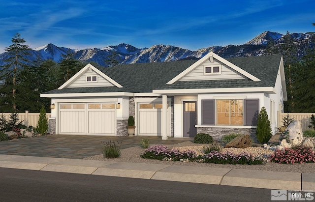 craftsman-style house with a garage and a mountain view