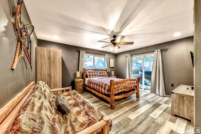 bedroom with access to exterior, ceiling fan, and light wood-type flooring