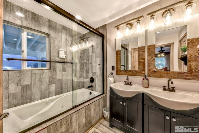 bathroom featuring ceiling fan, enclosed tub / shower combo, plenty of natural light, dual sinks, and oversized vanity