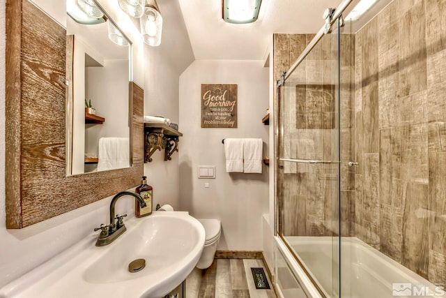 full bathroom with shower / bath combination with glass door, toilet, and sink