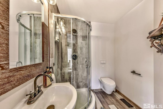 bathroom with walk in shower, toilet, and sink