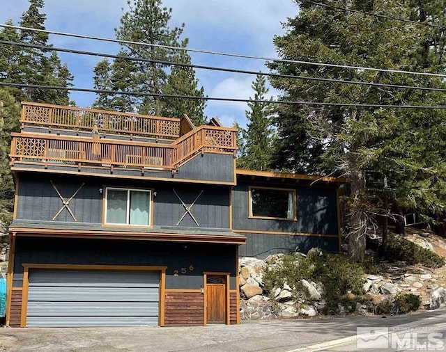 view of property featuring a balcony and a garage