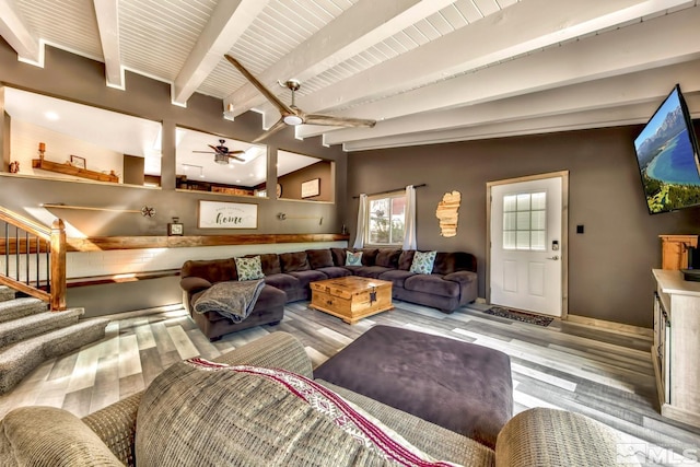 home theater featuring ceiling fan, lofted ceiling with beams, and wood-type flooring